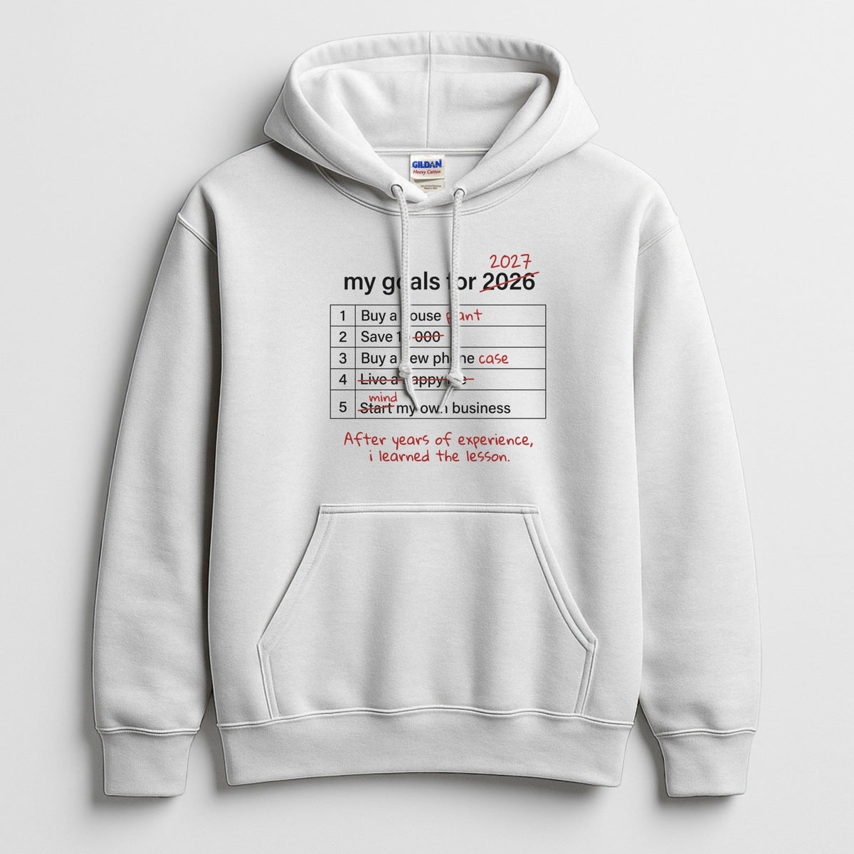 My Goals for 2027 white hoodie – funny New Year resolutions list with crossed-out goals like buy a house plant, Gildan 18500