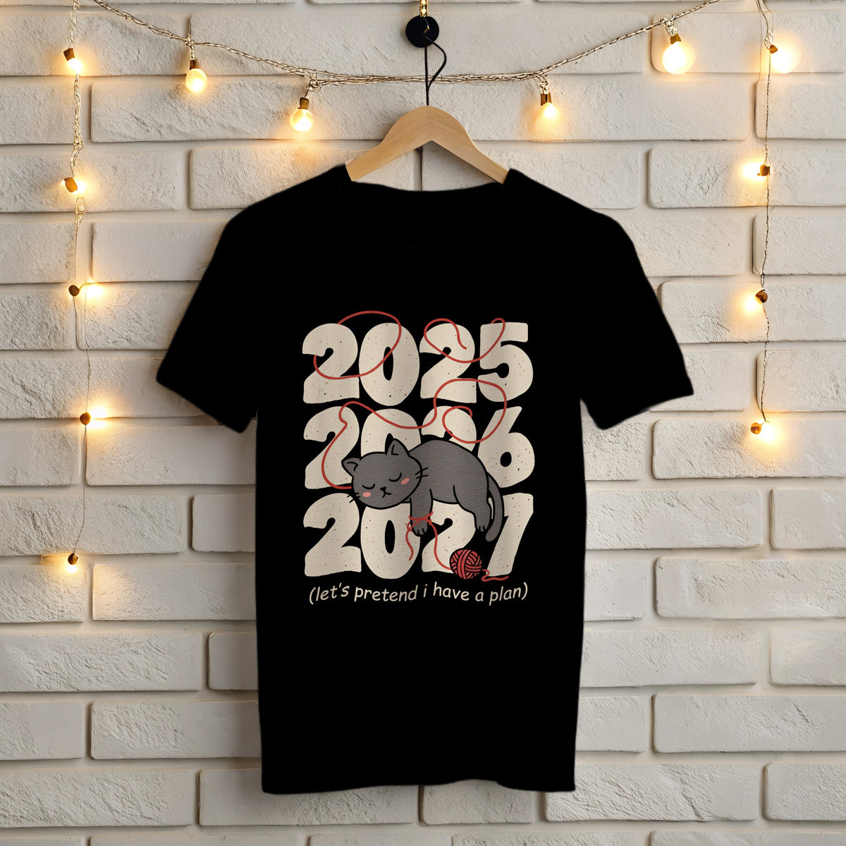 Let's Pretend I Have a Plan black t-shirt – sleepy gray cat tangled in red yarn over 2025, 2026 and 2027, Gildan 5000
