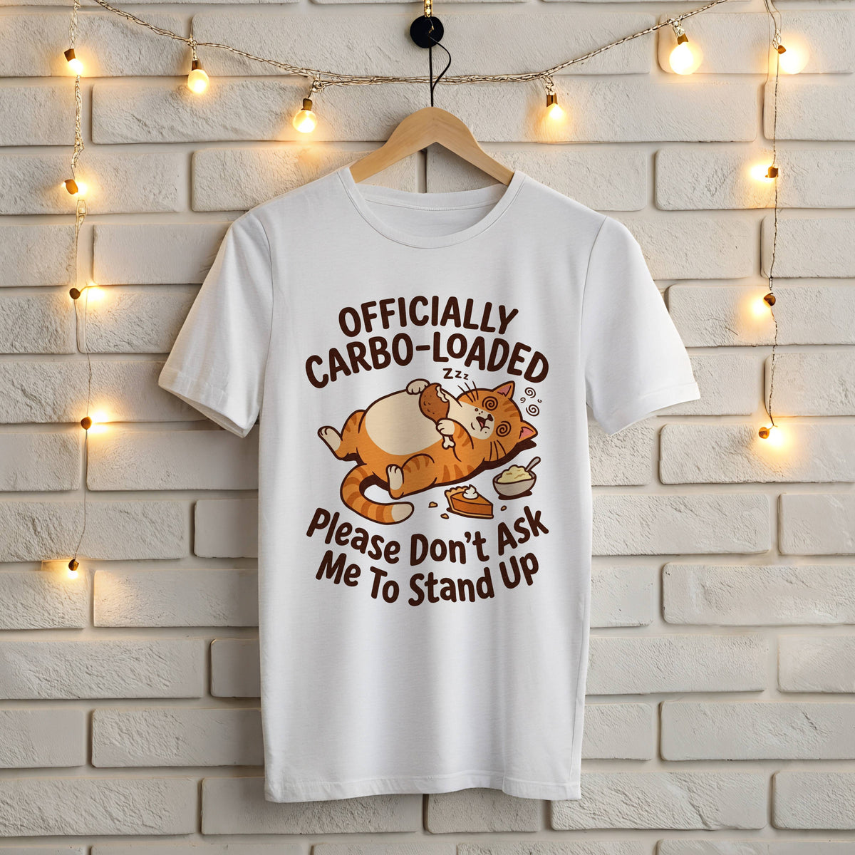 White Gildan 5000 t-shirt with funny Officially Carbo-Loaded Thanksgiving orange cat holding a turkey leg next to pie and mashed potatoes