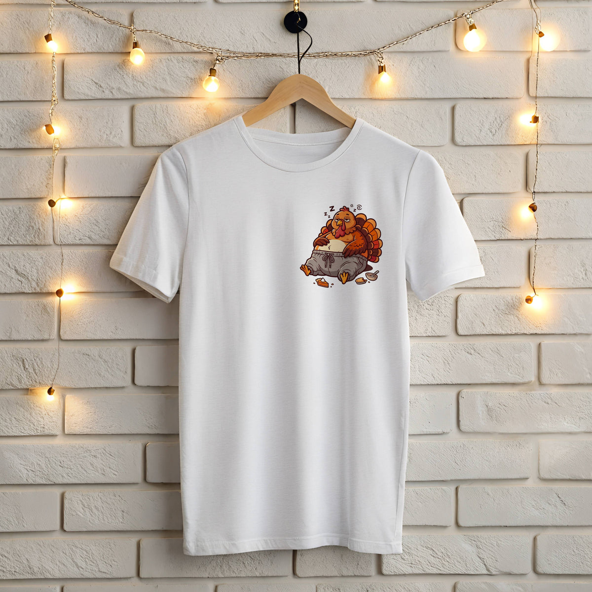 White Gildan 5000 t-shirt with small left chest Thanksgiving print of a sleepy stuffed turkey in gray sweatpants