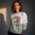 Woman wearing a white Gildan 18000 crewneck sweatshirt with funny Officially Carbo-Loaded Thanksgiving orange cat holding a turkey leg