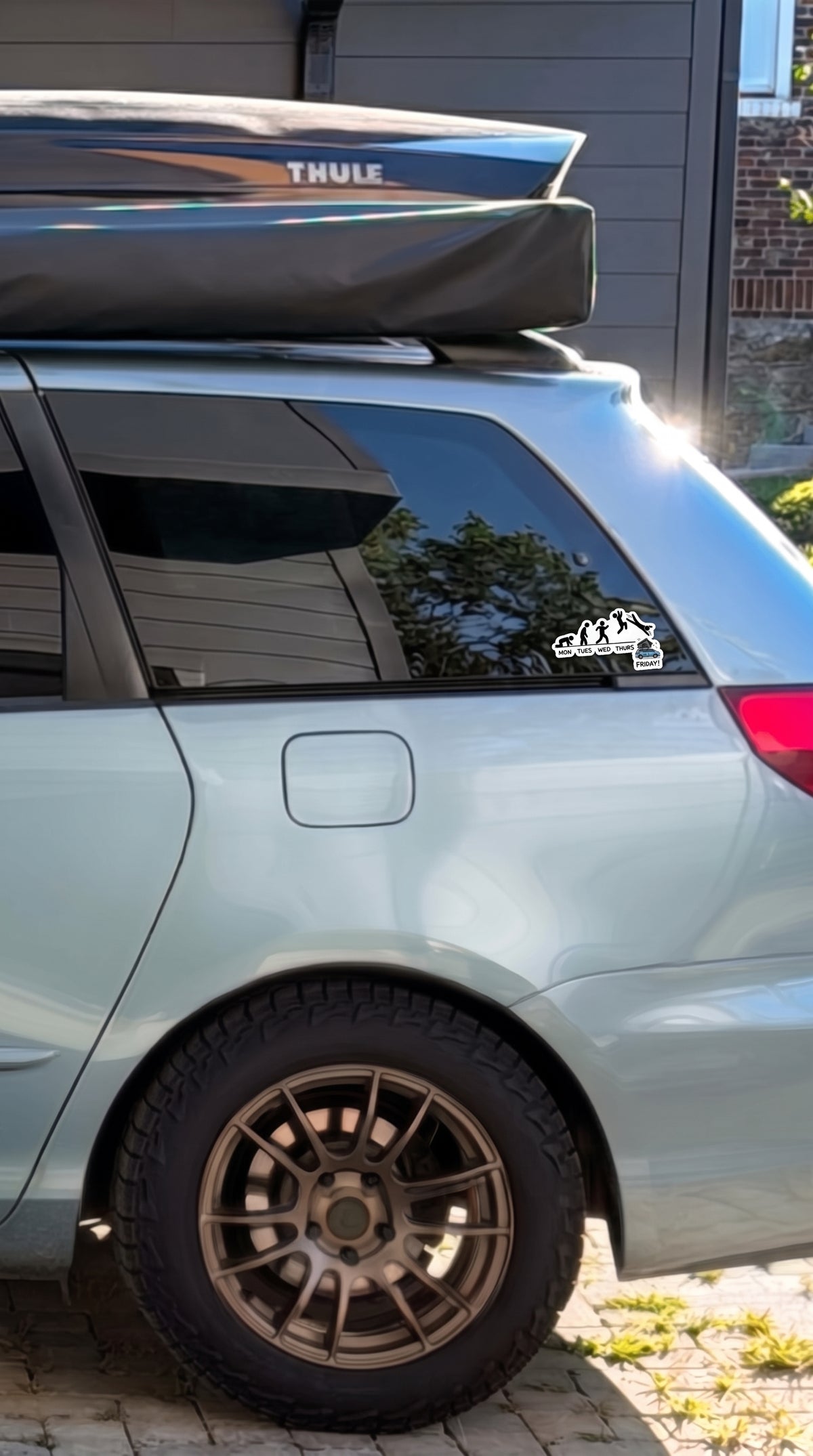 Mon to Friday waterproof sticker on a minivan rear side window with a roof cargo box