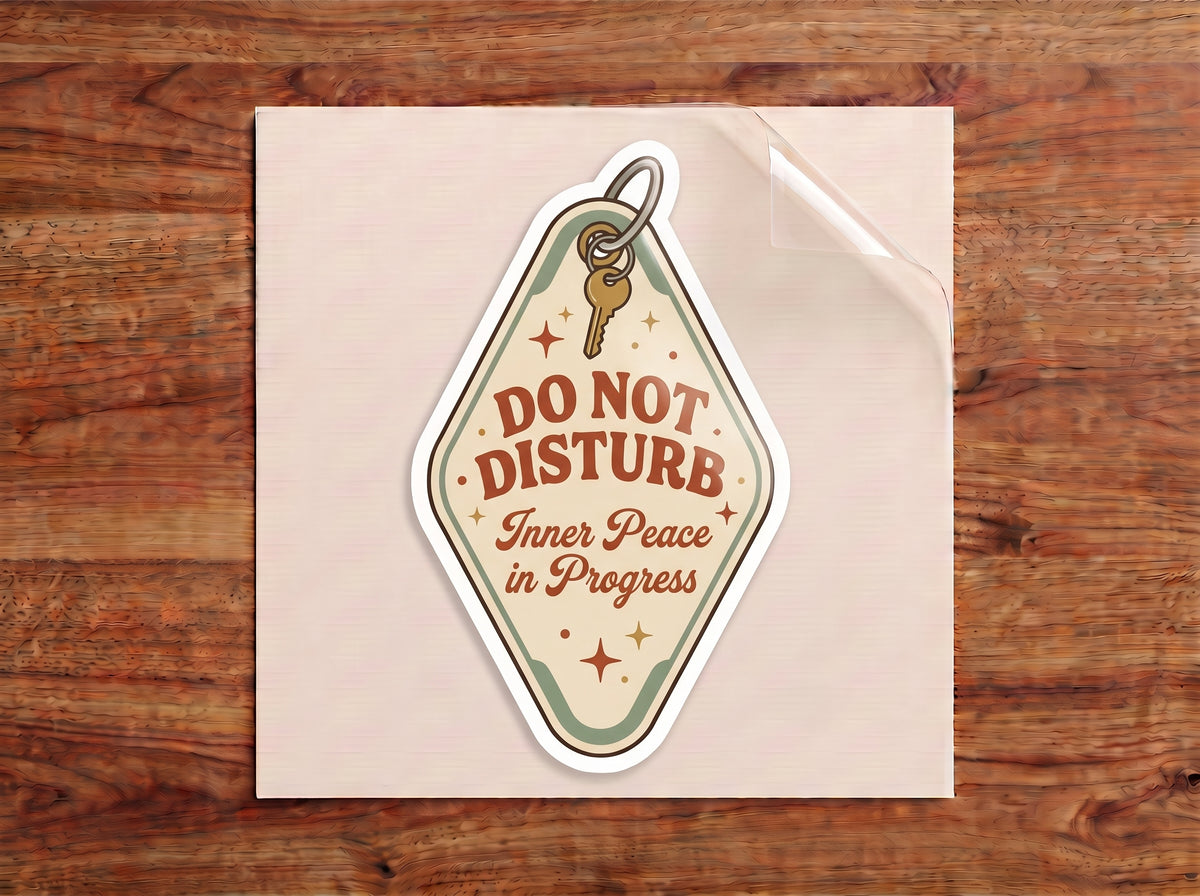 Do Not Disturb Inner Peace in Progress waterproof sticker on a cream leather journal with coffee and plants