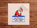 Low Battery Do Not Disturb Until 2027 sticker – tired Santa at 1% battery leaning on a retro computer pop-up window
