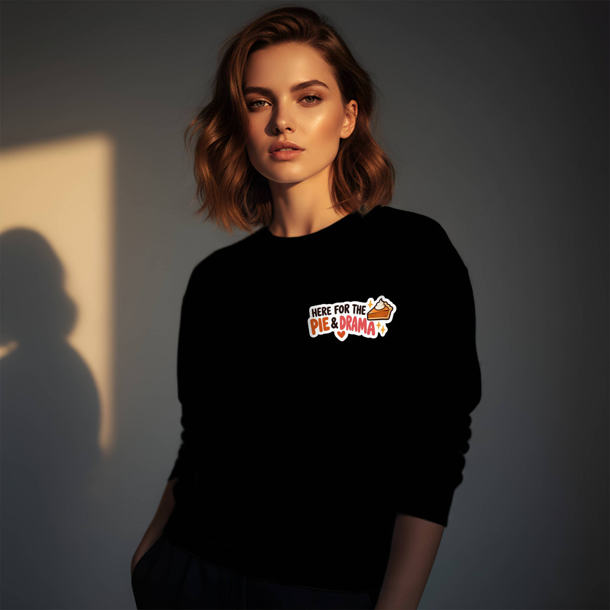 Woman wearing a black Gildan 18000 crewneck sweatshirt with small left chest Here for the Pie & Drama Thanksgiving print